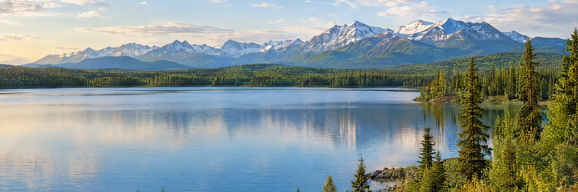 Illustration inspired by Wasilla, AK: southcentral Alaska lake with boreal woods and distant mountains.