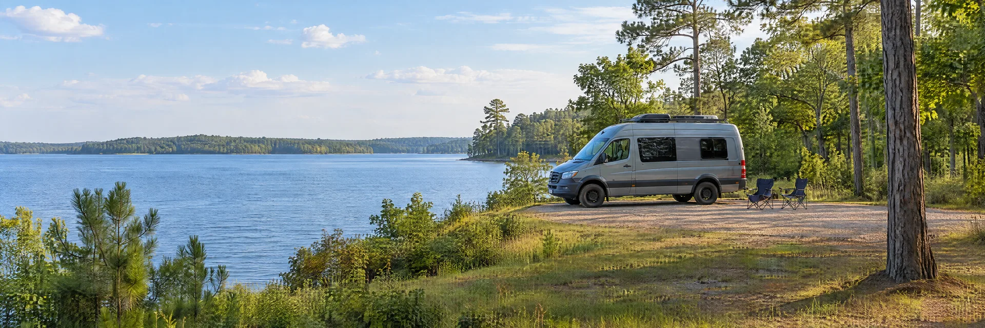 Illustration of a camper van at a fictional camping setting inspired by Eufaula, AL.