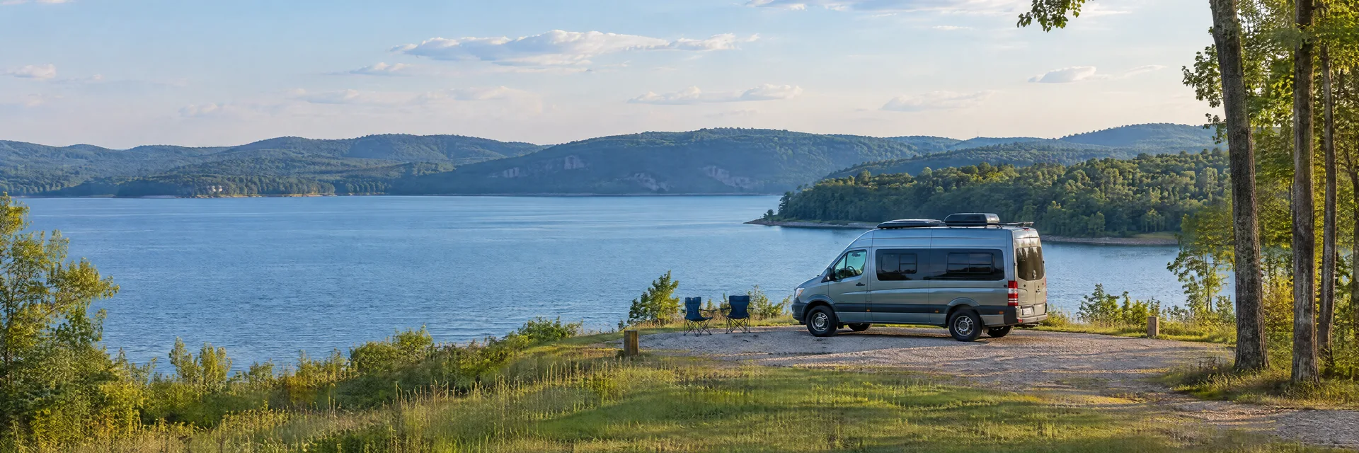 Illustration of a camper van at a fictional camping setting inspired by Florence, AL.