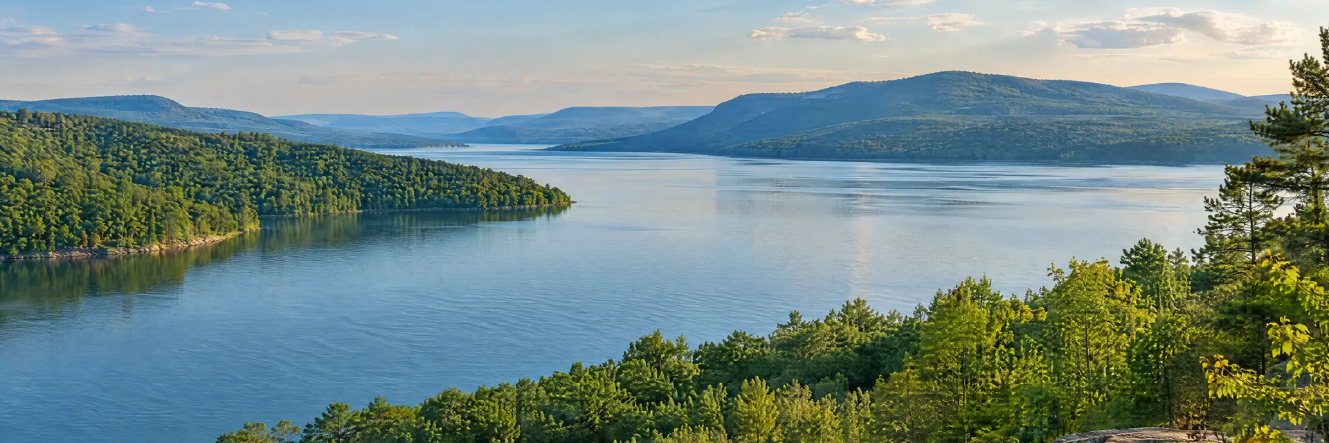 Illustration inspired by Guntersville, AL: north Alabama broad lake framed by forested low mountain ridges.