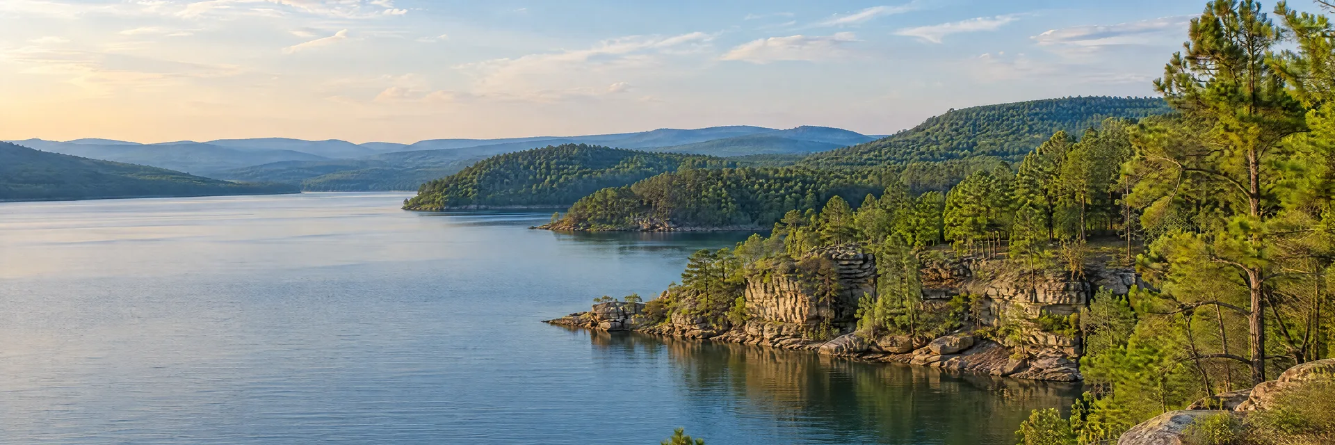 Illustration inspired by Dierks, AR: southwestern Arkansas pine-covered hills, calm reservoir and rocky wooded shoreline.