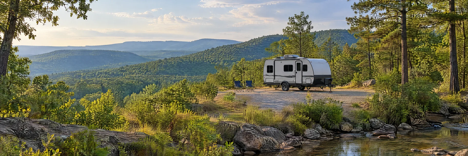 Illustration of a compact travel trailer at a fictional camping setting inspired by Fountain Lake, AR.