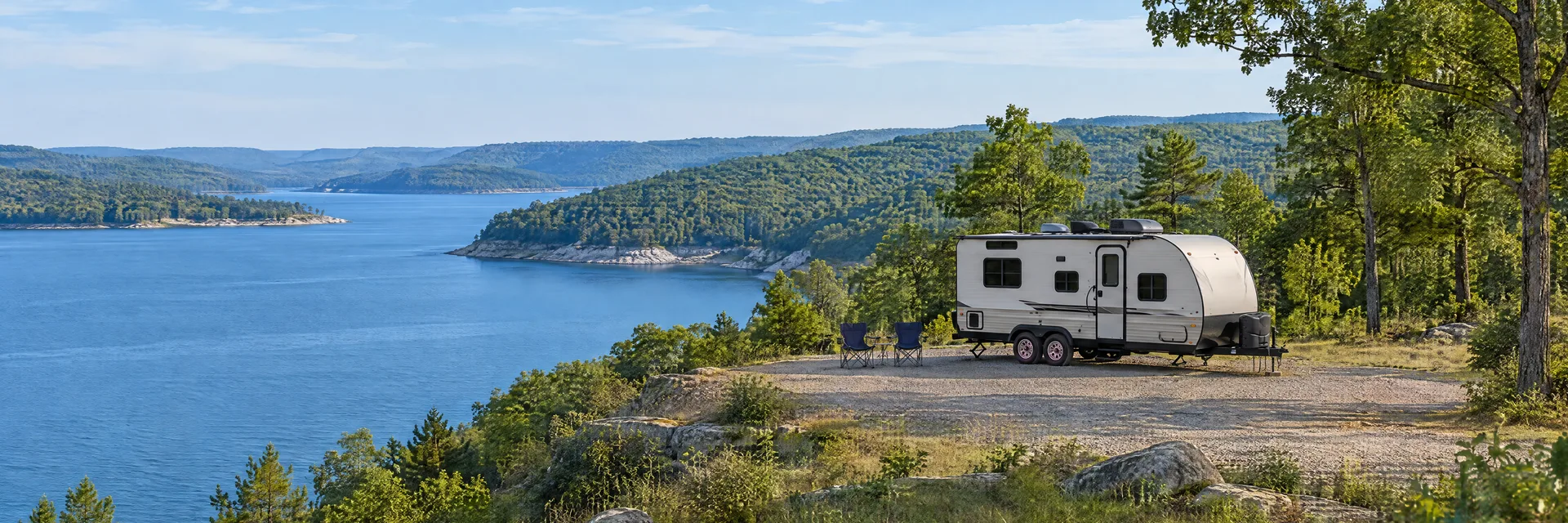 Illustration of a compact travel trailer at a fictional camping setting inspired by Greers Ferry, AR.