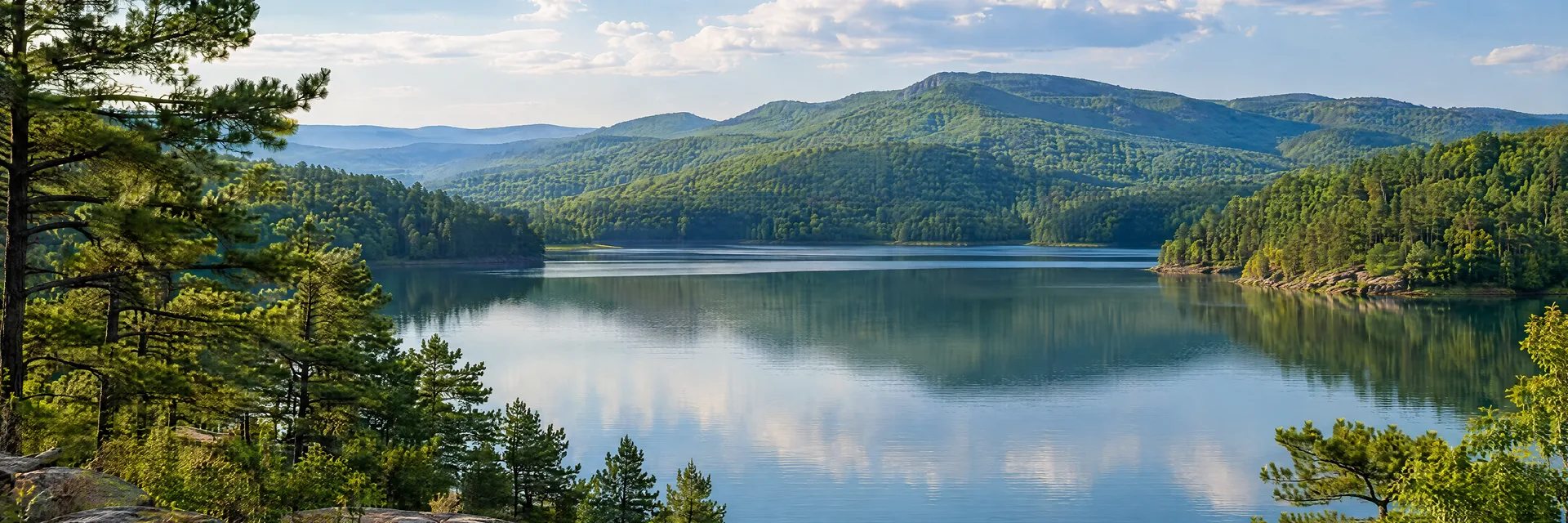 Illustration inspired by Hot Springs, AR: ouachita forested hills reflected in a quiet Arkansas lake.