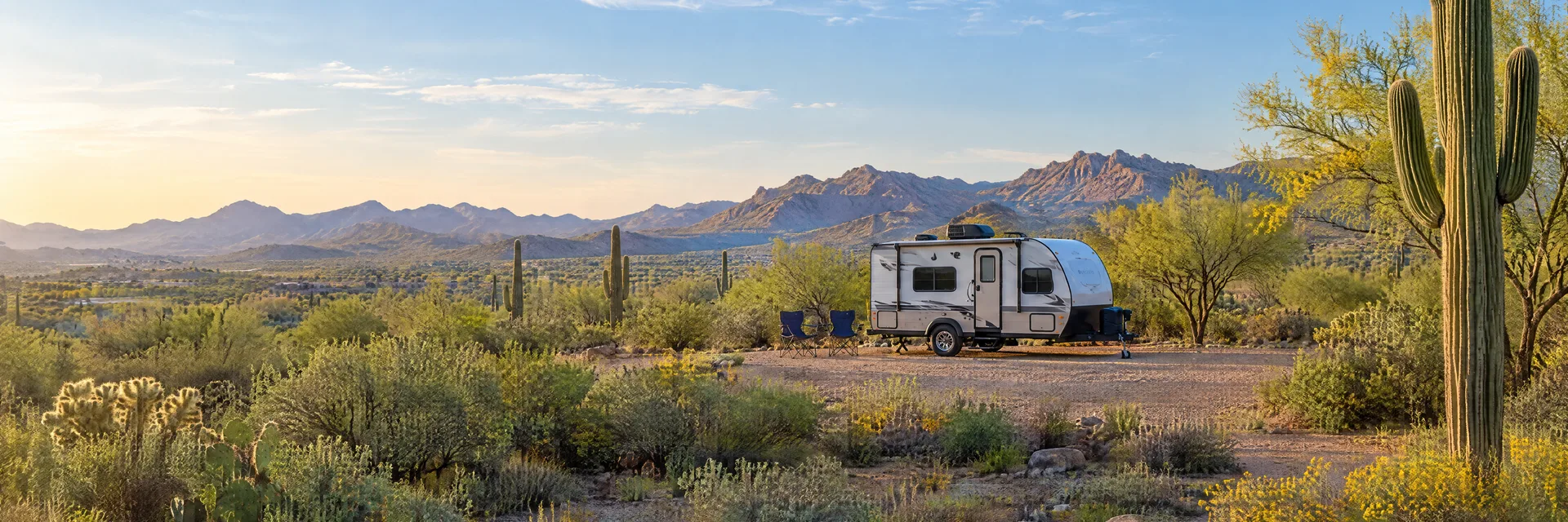 Illustration of a compact travel trailer at a fictional camping setting inspired by Chandler, AZ.