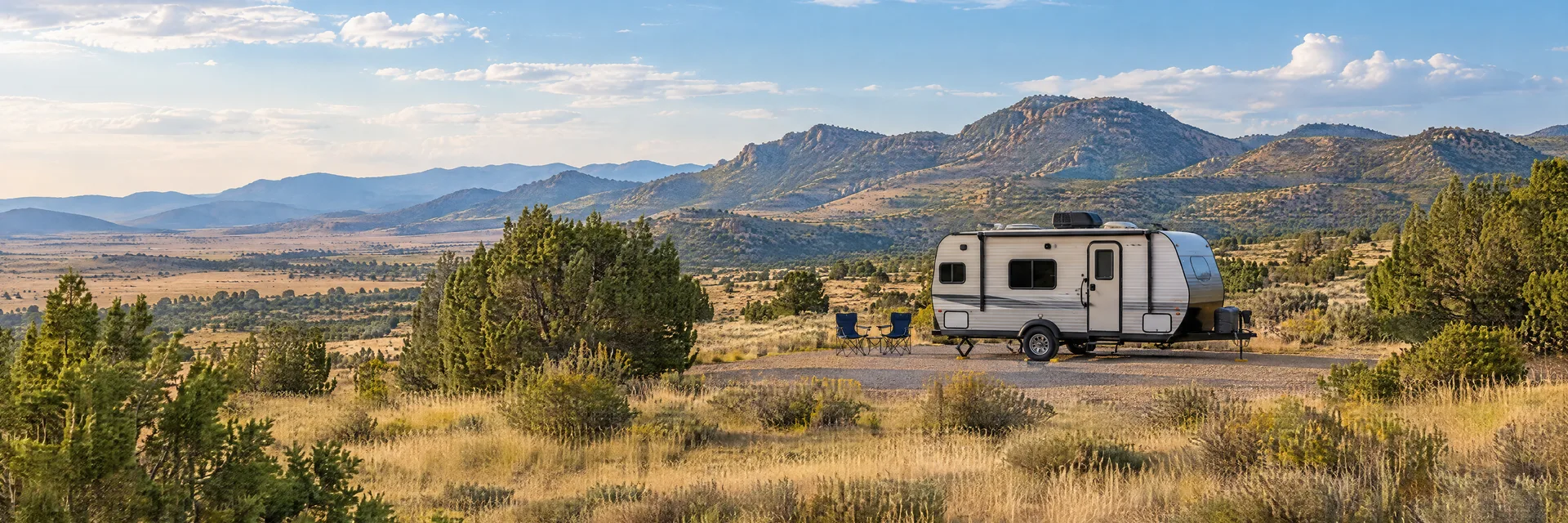 Illustration of a compact travel trailer at a fictional camping setting inspired by Prescott Valley, AZ.