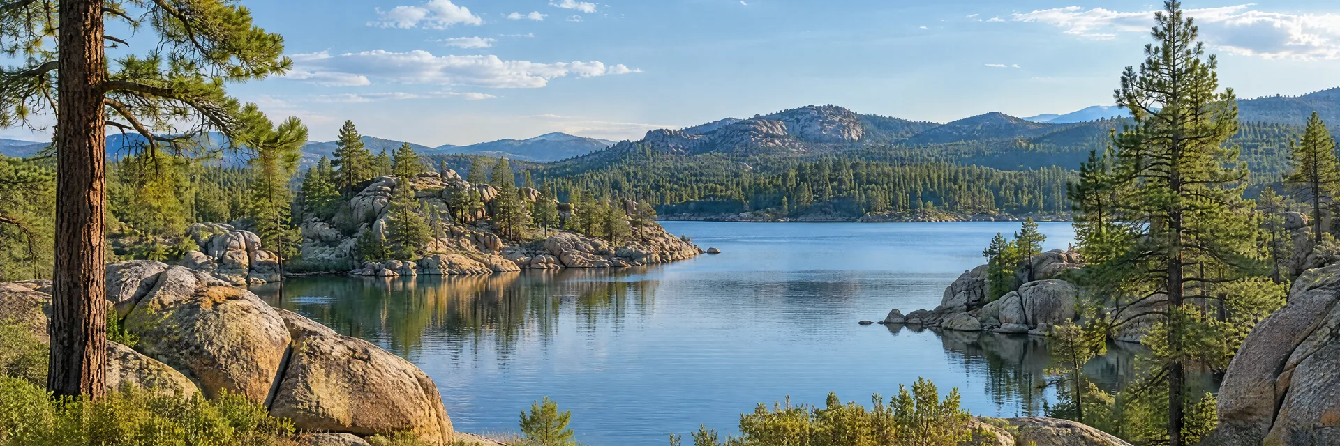 Illustration inspired by Prescott, AZ: granite boulders and ponderosa pines around a small Arizona lake.