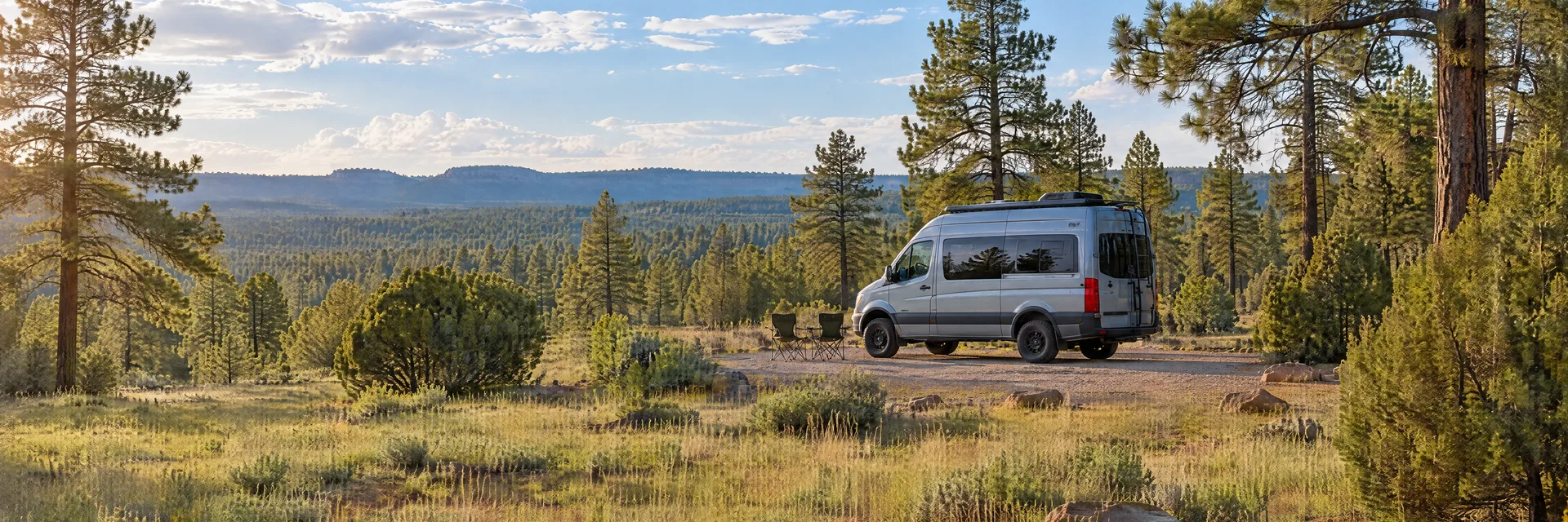 Illustration of a camper van at a fictional camping setting inspired by Tusayan, AZ.