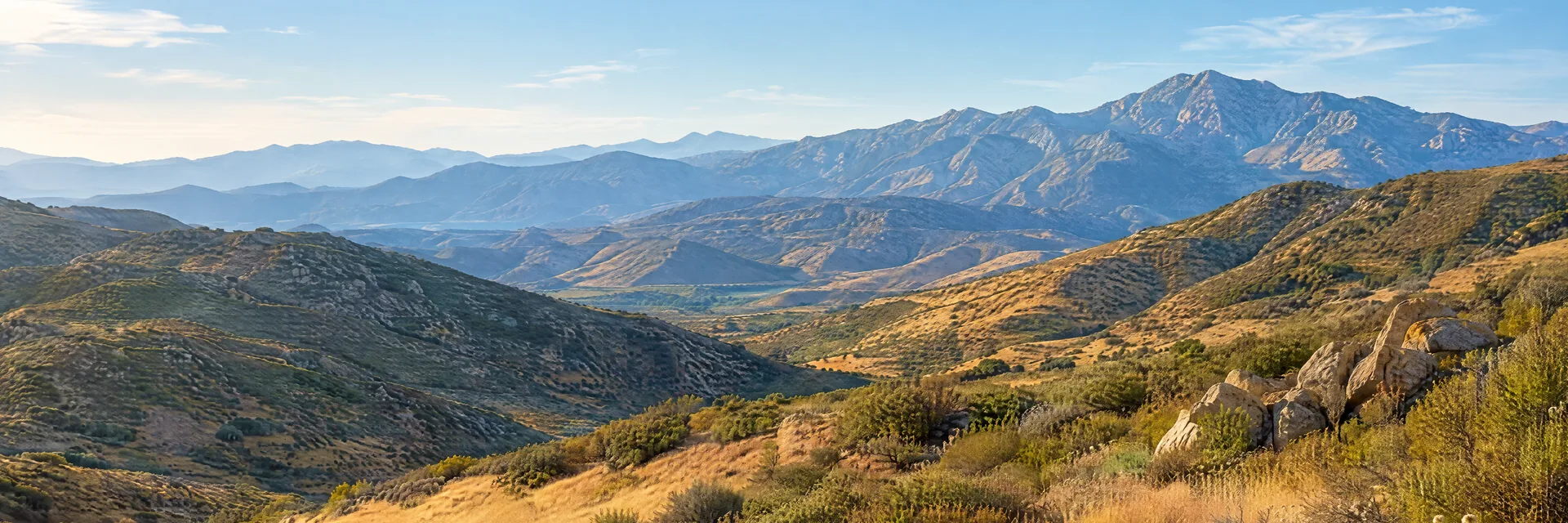 Illustration inspired by Banning, CA: southern California inland mountain pass region, golden grassland, dry chaparral slopes and distant rugged mountain ridges.