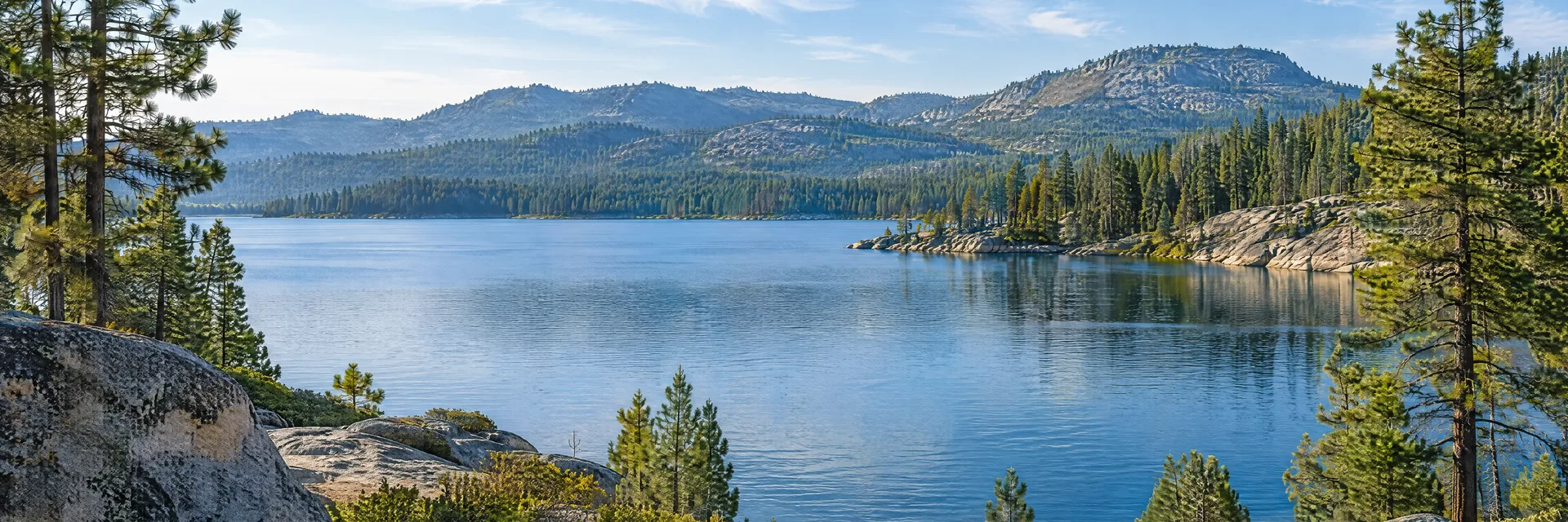 Illustration inspired by Bass Lake, CA: sierra foothill lake with pine forest and granite shoreline.