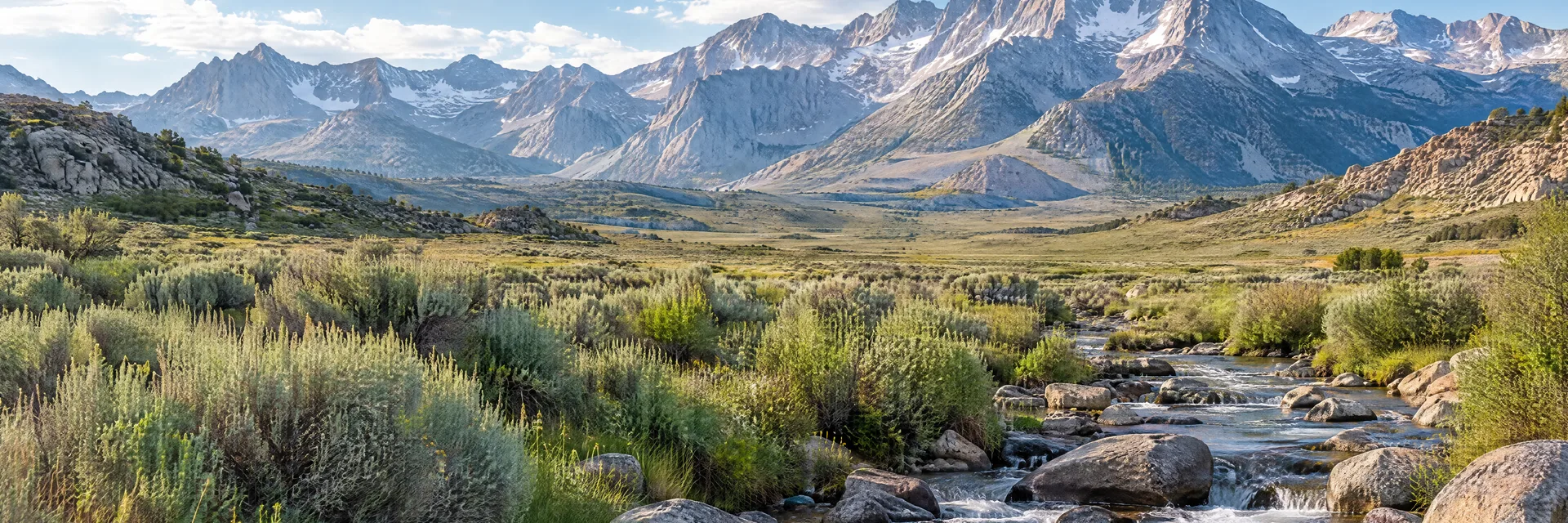 Illustration inspired by Bishop, CA: eastern Sierra sagebrush valley and rocky creek beneath steep alpine peaks.