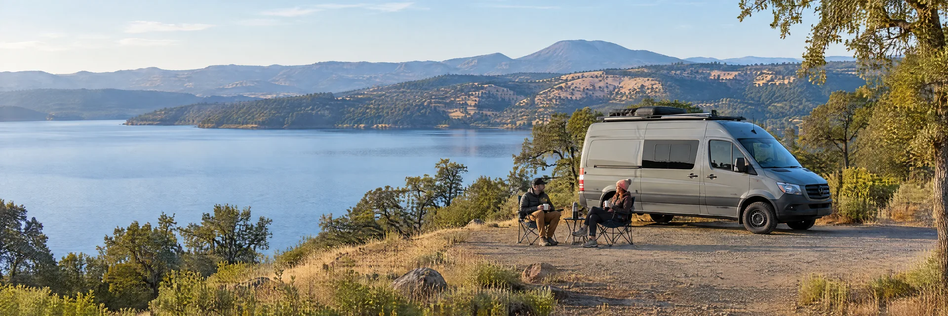Illustration of campers enjoying morning coffee beside a camper van in a fictional camping setting inspired by Clearlake, CA.