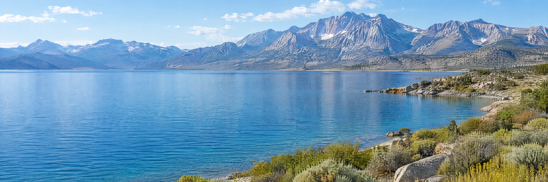 Illustration inspired by Crowley Lake, CA: eastern Sierra blue lake, sagebrush shore and distant rugged granite mountains.