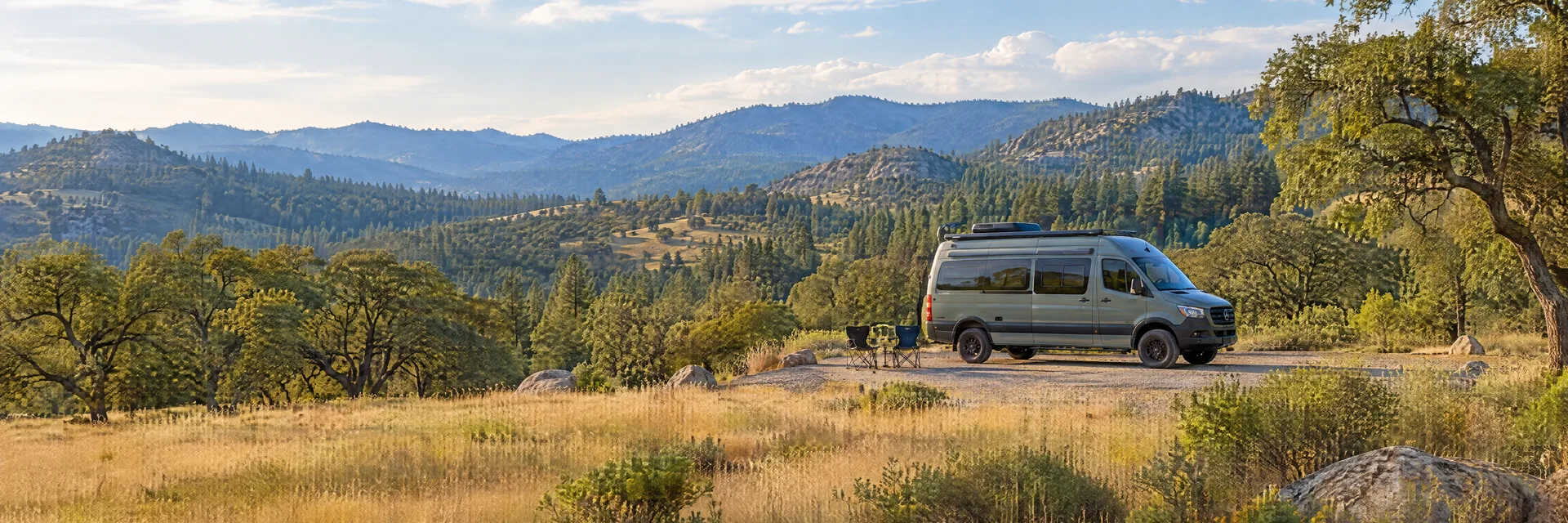 Illustration of a camper van at a fictional camping setting inspired by Julian, CA.