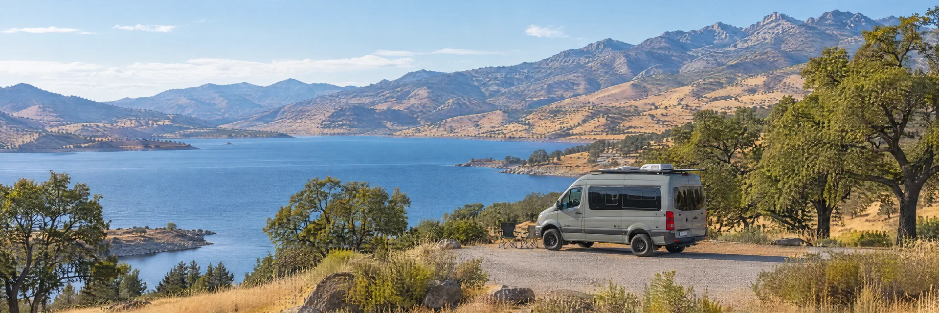 Illustration of a camper van at a fictional camping setting inspired by Lake Isabella, CA.