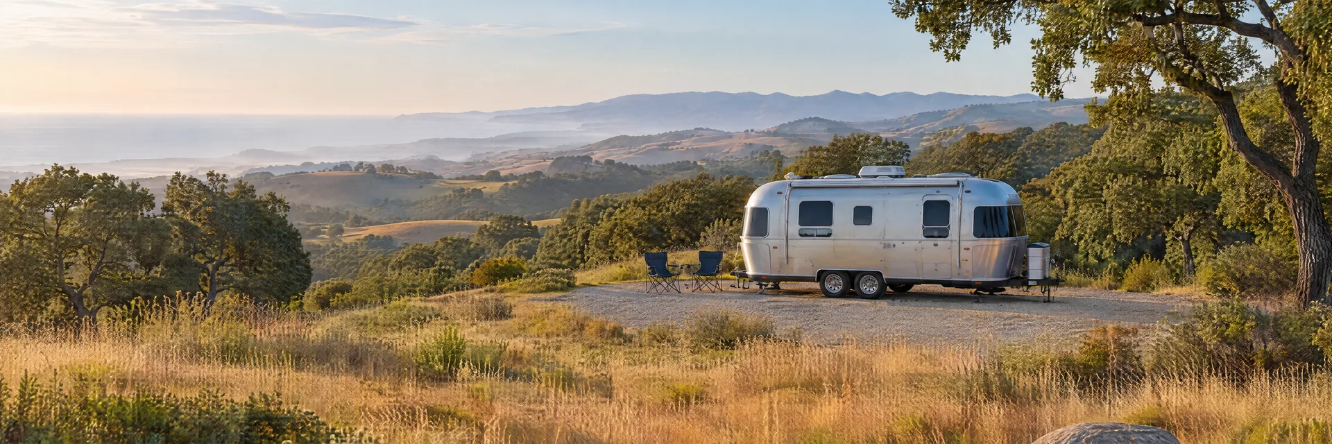 Illustration of a rounded silver travel trailer at a fictional camping setting inspired by Lompoc, CA.
