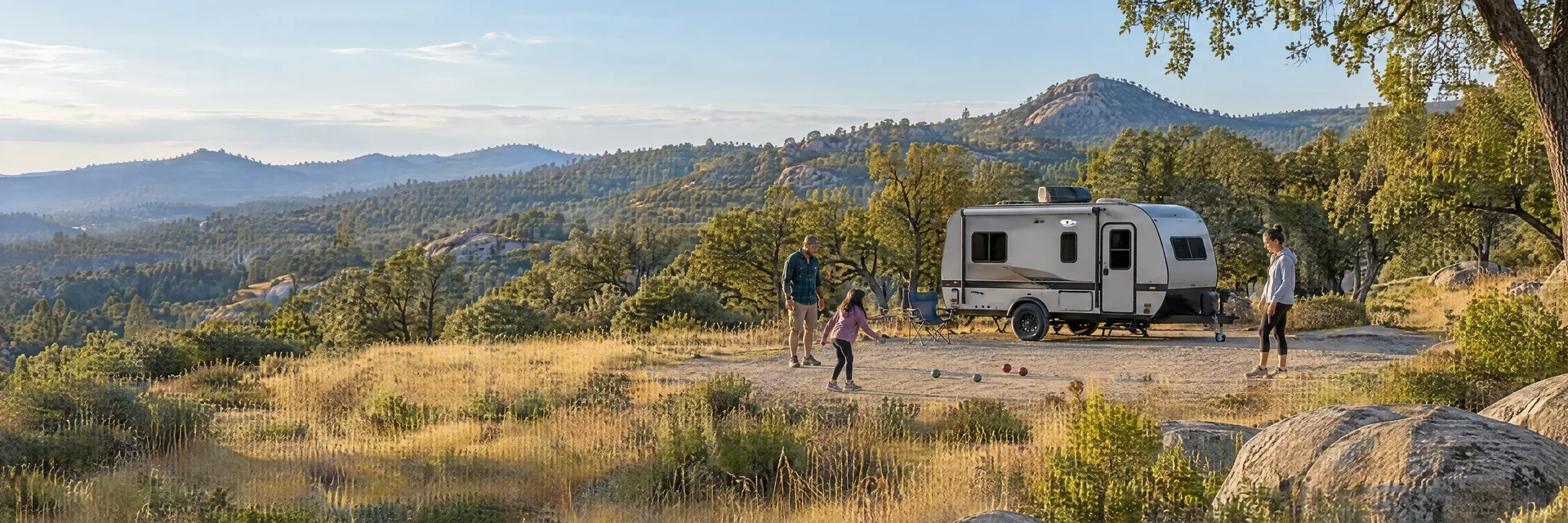Illustration of campers enjoying family campsite activities beside a compact travel trailer in a fictional camping setting inspired by Loomis, CA.