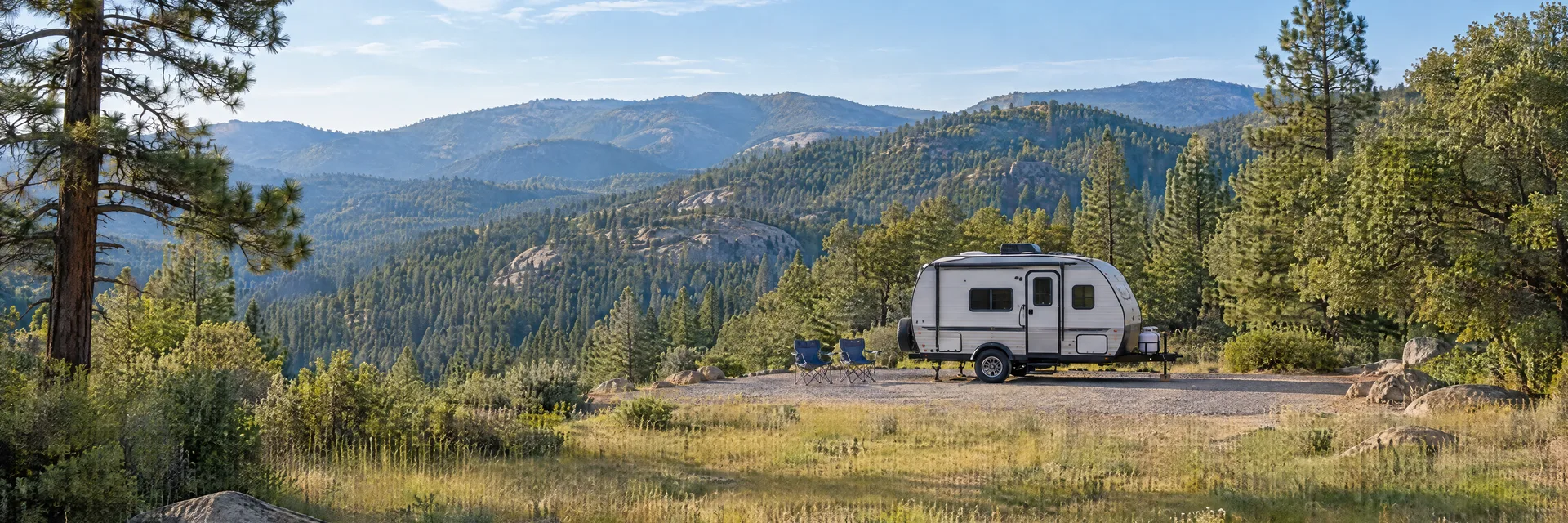 Illustration of a compact travel trailer at a fictional camping setting inspired by Palomar Mountain, CA.