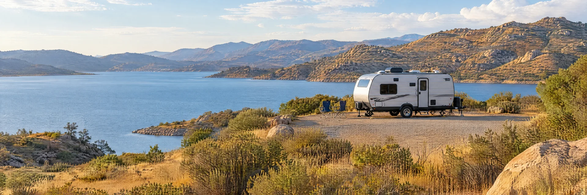 Illustration of a compact travel trailer at a fictional camping setting inspired by Perris, CA.