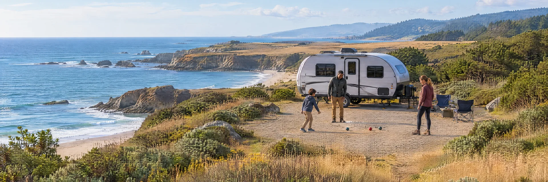 Illustration of campers enjoying family campsite activities beside a compact travel trailer in a fictional camping setting inspired by Pescadero, CA.