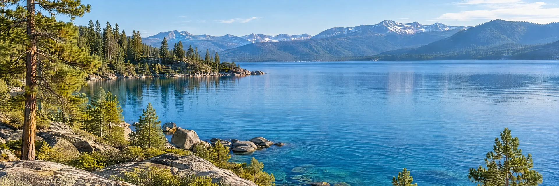 Illustration inspired by South Lake Tahoe, CA: clear blue Sierra lake with granite shoreline and conifer forest.