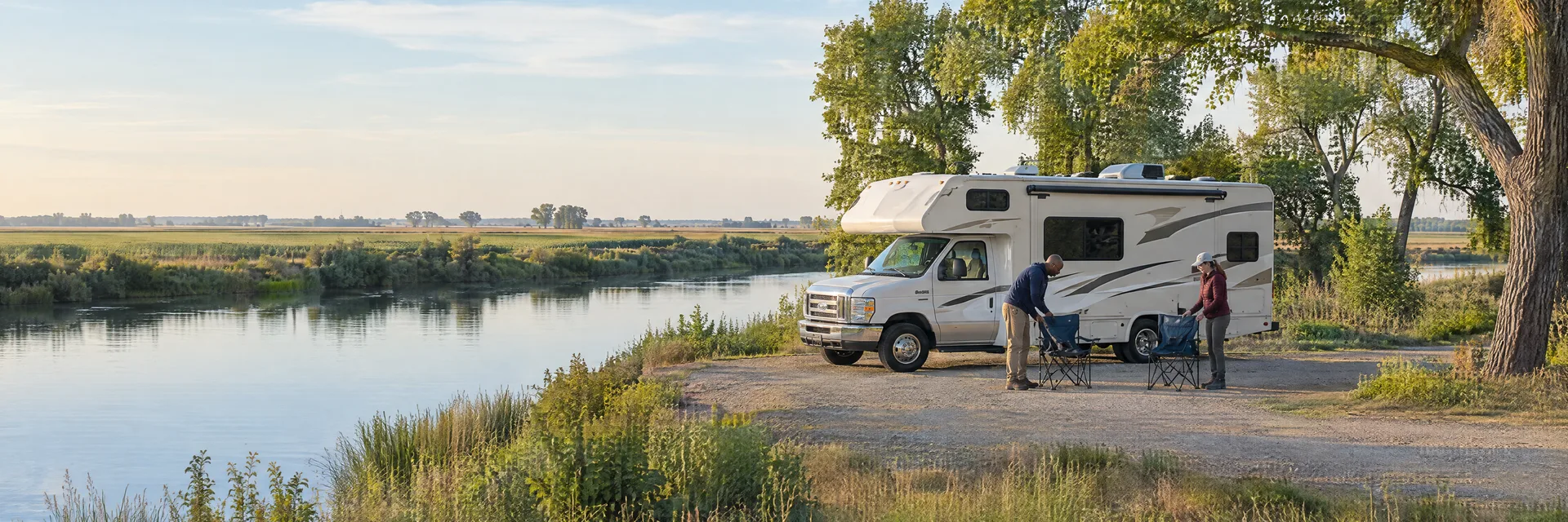 Illustration of campers enjoying setting up camp beside a Class C motorhome in a fictional camping setting inspired by Stockton, CA.