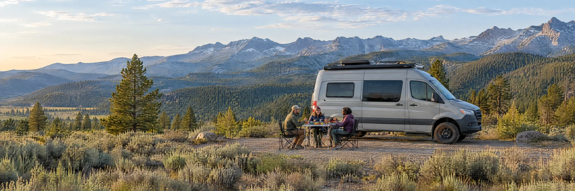 Illustration of campers enjoying an outdoor meal beside a camper van in a fictional camping setting inspired by Susanville, CA.