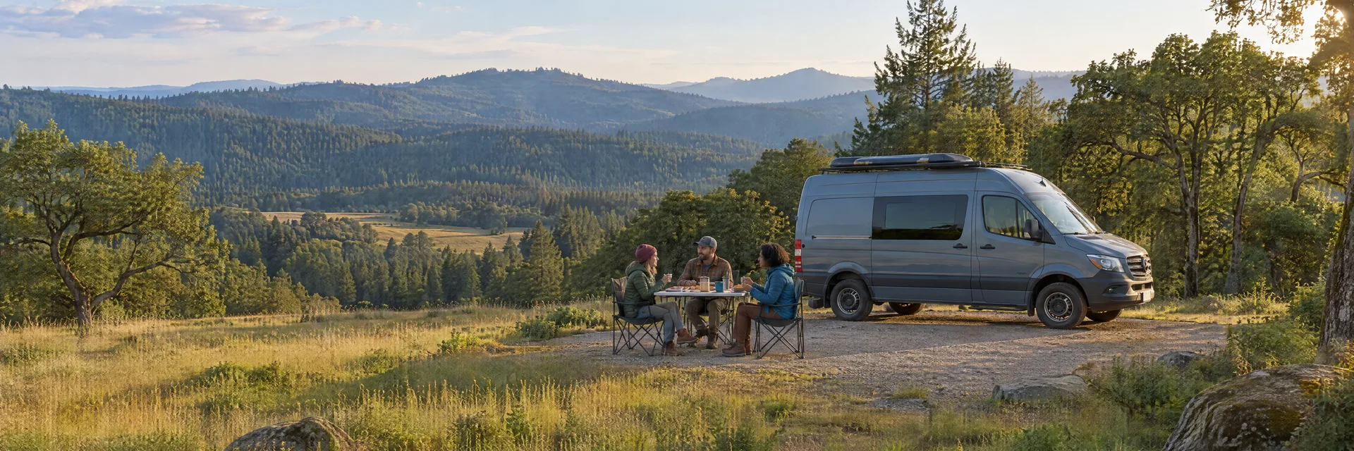 Illustration of campers enjoying an outdoor meal beside a camper van in a fictional camping setting inspired by Willits, CA.
