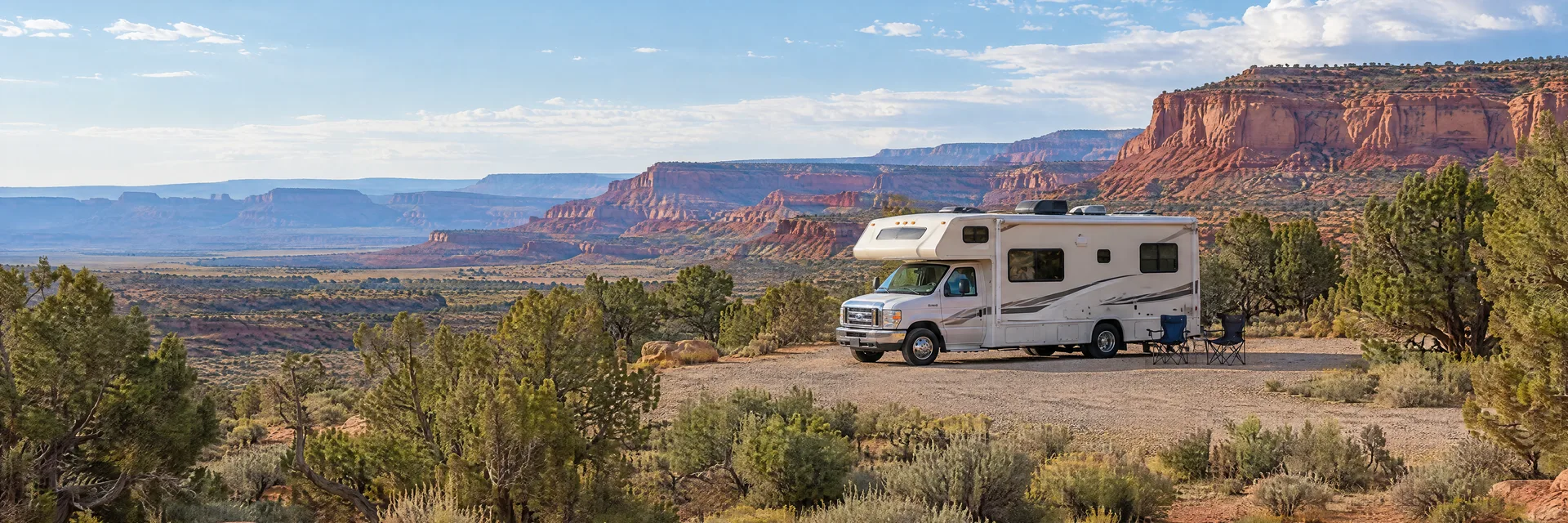 Illustration of a Class C motorhome at a fictional camping setting inspired by Fruita, CO.