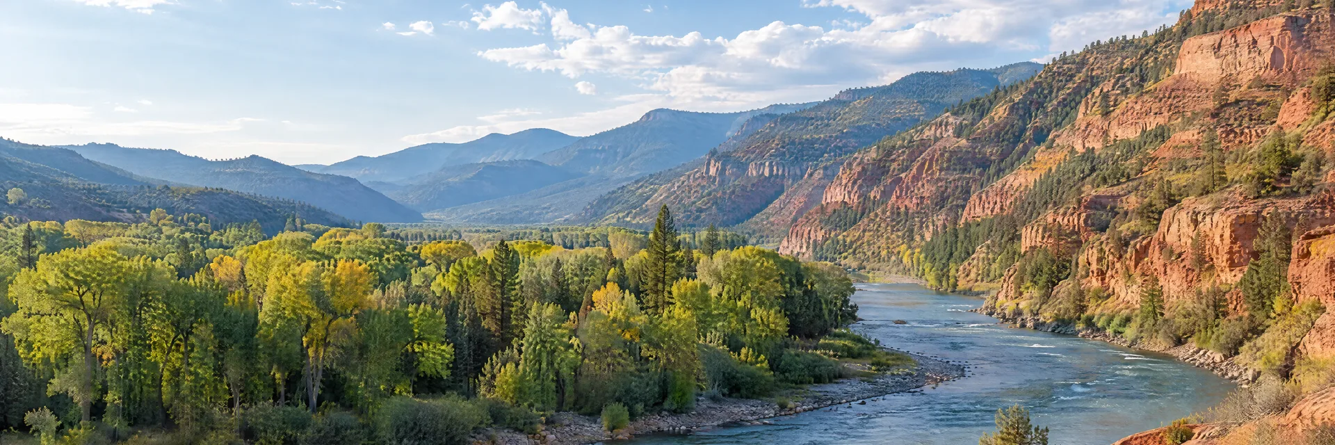 Illustration inspired by Glenwood Springs, CO: colorado river canyon, reddish rock slopes and mixed cottonwood and conifer woodland.