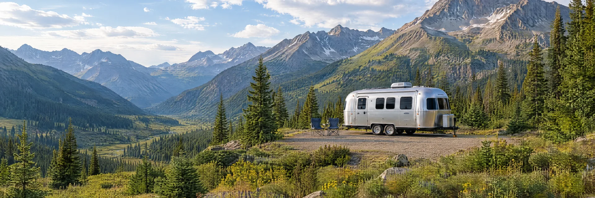 Illustration of a rounded silver travel trailer at a fictional camping setting inspired by Silverton, CO.