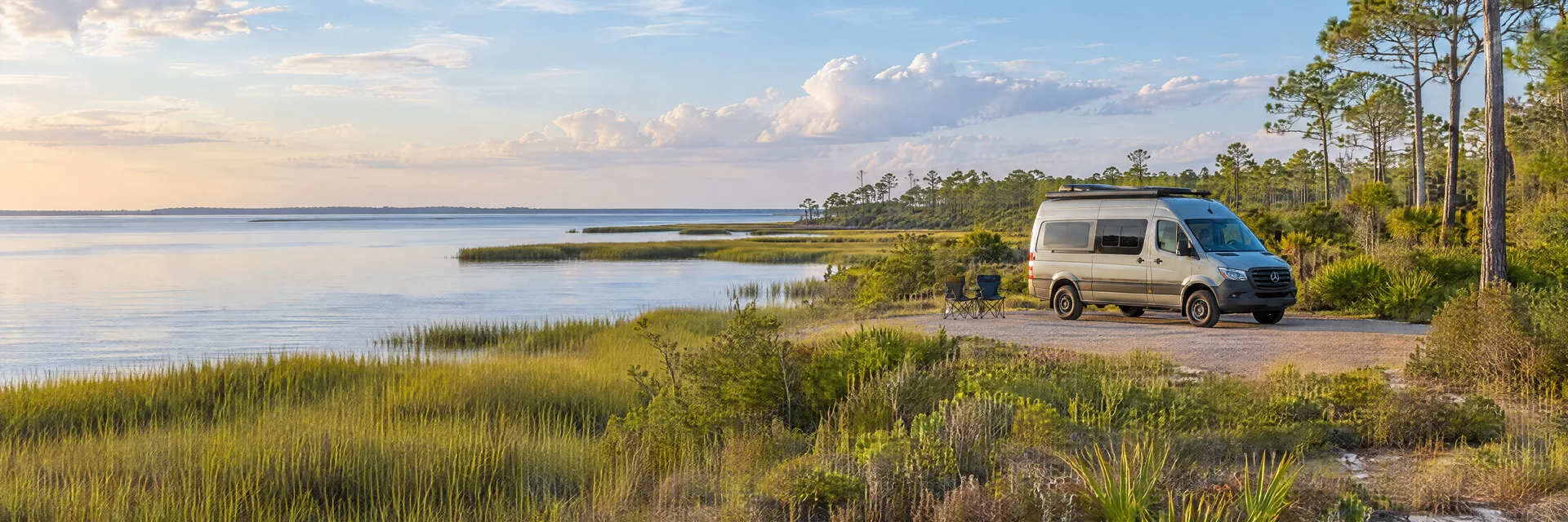 Illustration of a camper van at a fictional camping setting inspired by Apalachicola, FL.