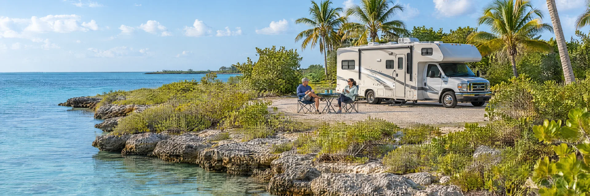 Illustration of campers enjoying morning coffee beside a Class C motorhome in a fictional camping setting inspired by Big Pine Key, FL.