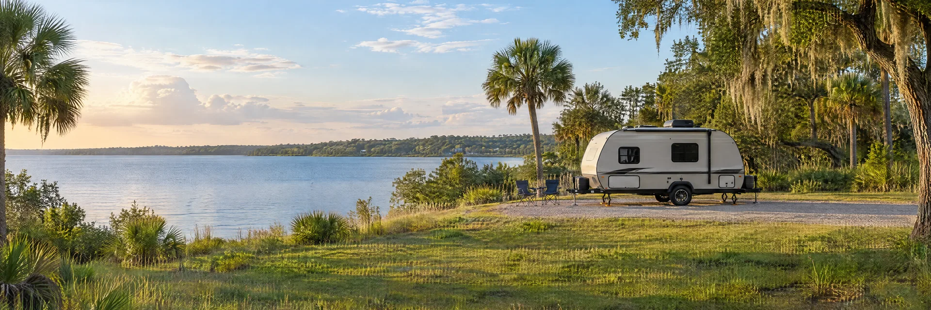 Illustration of a compact travel trailer at a fictional camping setting inspired by Clermont, FL.