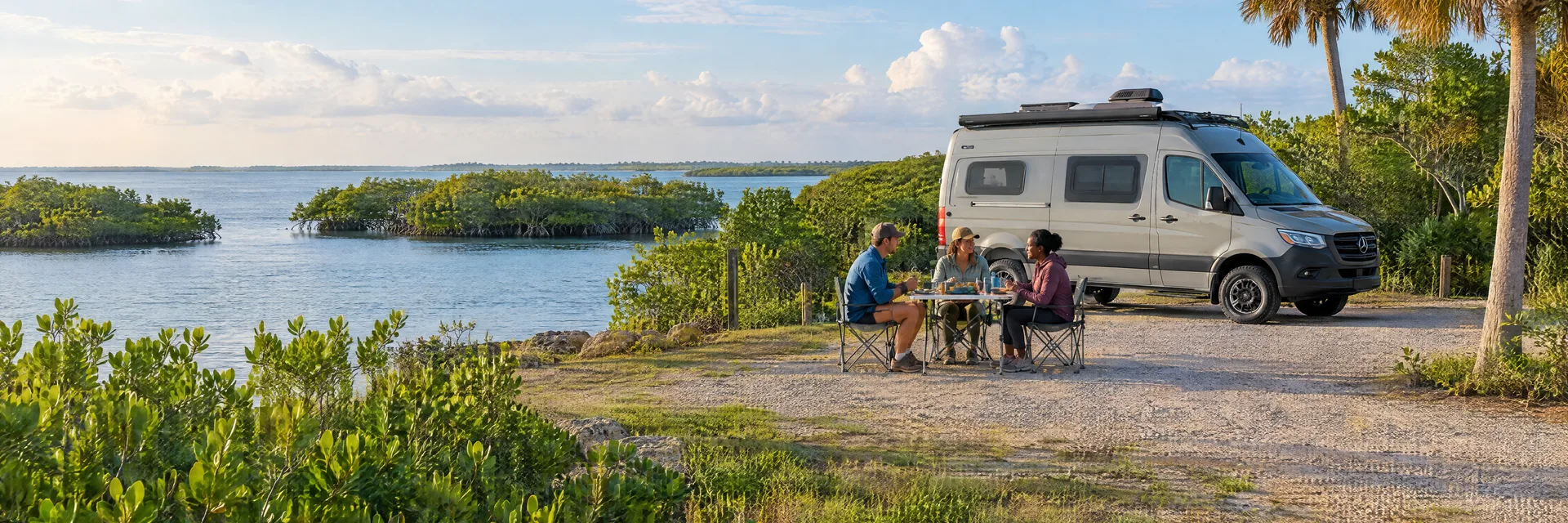 Illustration of campers enjoying an outdoor meal beside a camper van in a fictional camping setting inspired by Marco Island, FL.