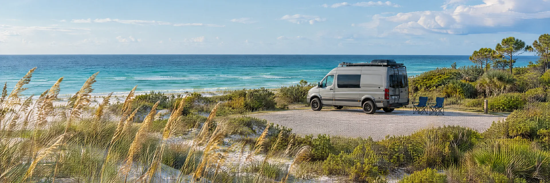 Illustration of a camper van at a fictional camping setting inspired by Miramar Beach, FL.