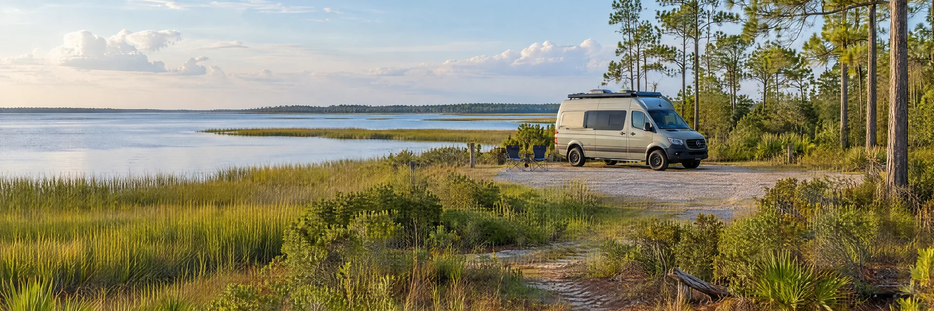 Illustration of a camper van at a fictional camping setting inspired by Panacea, FL.