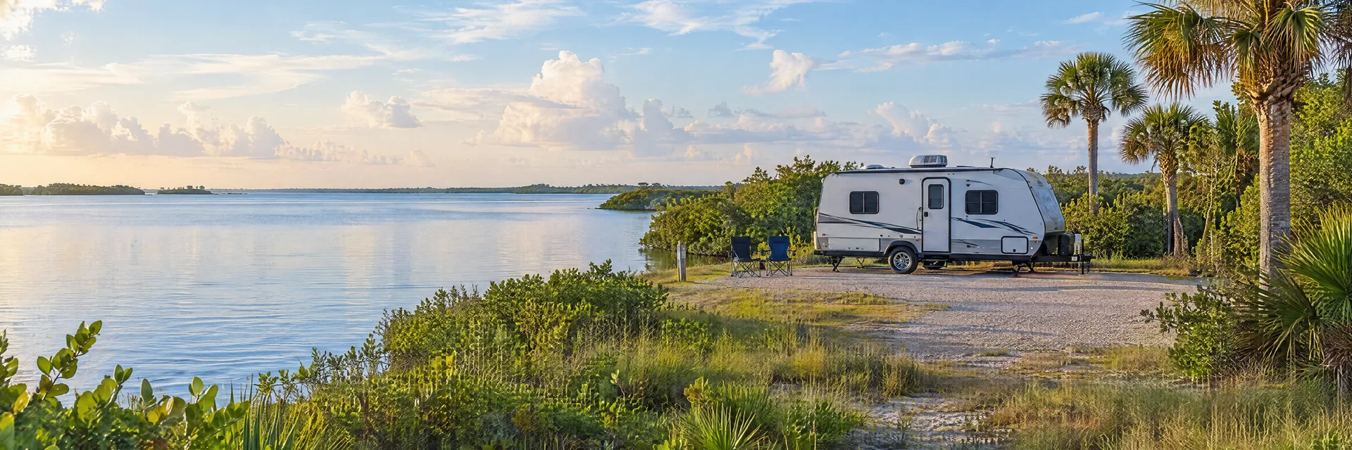 Illustration of a compact travel trailer at a fictional camping setting inspired by Sebastian, FL.