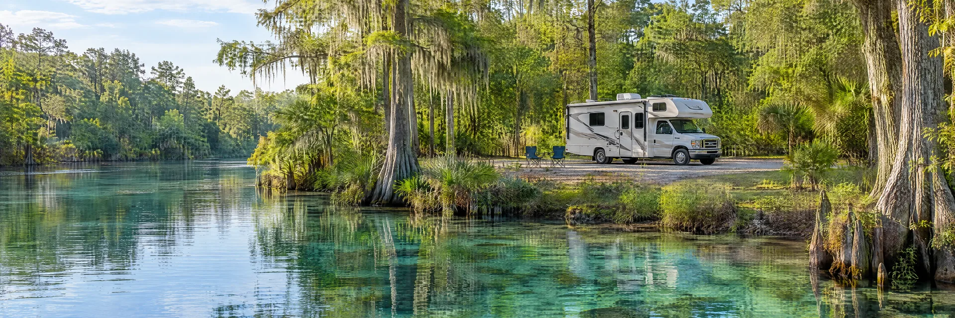 Illustration of a Class C motorhome at a fictional camping setting inspired by Silver Springs, FL.