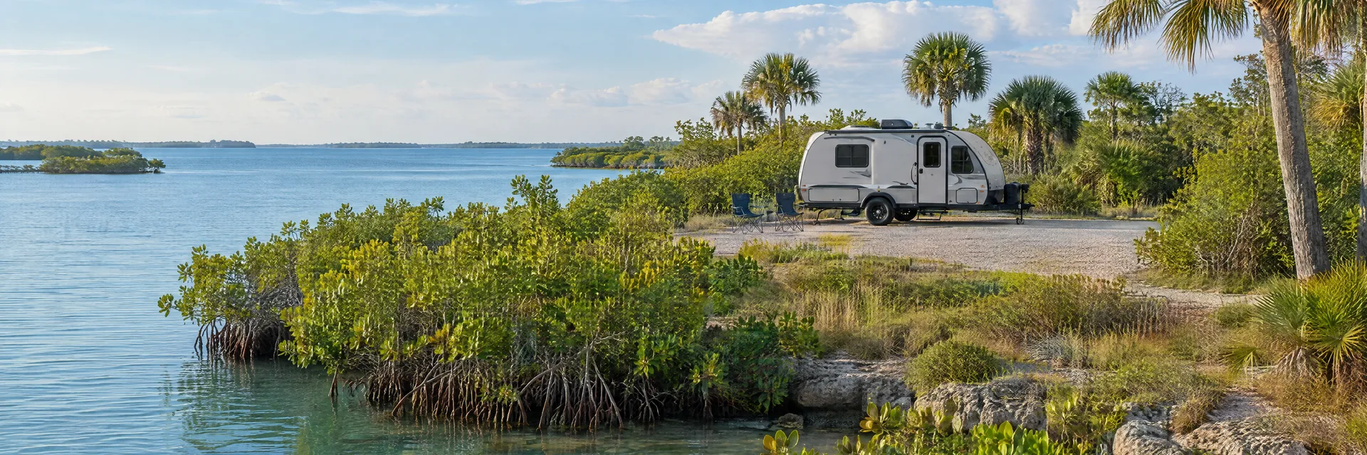 Illustration of a compact travel trailer at a fictional camping setting inspired by Tampa, FL.