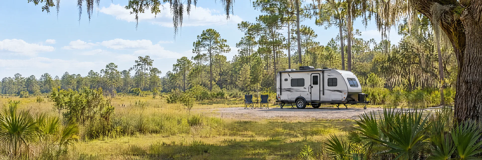 Illustration of a compact travel trailer at a fictional camping setting inspired by Zephyrhills, FL.