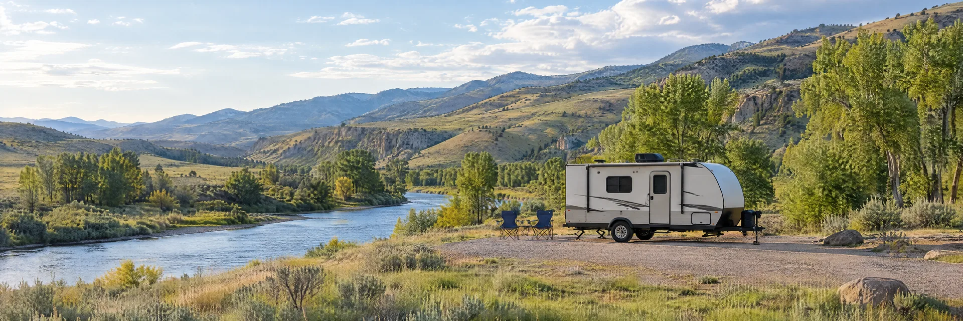 Illustration of a compact travel trailer at a fictional camping setting inspired by Lava Hot Springs, ID.
