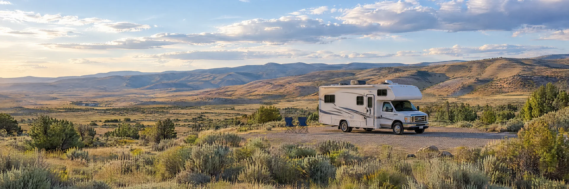 Illustration of a Class C motorhome at a fictional camping setting inspired by Mountain Home, ID.