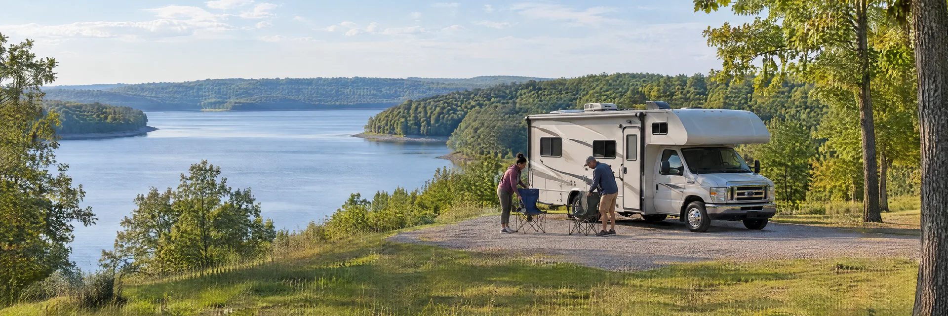 Illustration of campers enjoying setting up camp beside a Class C motorhome in a fictional camping setting inspired by Shelbyville, IL.