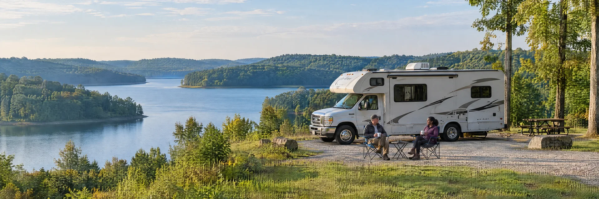 Illustration of campers enjoying morning coffee beside a Class C motorhome in a fictional camping setting inspired by BROOKVILLE, IN.