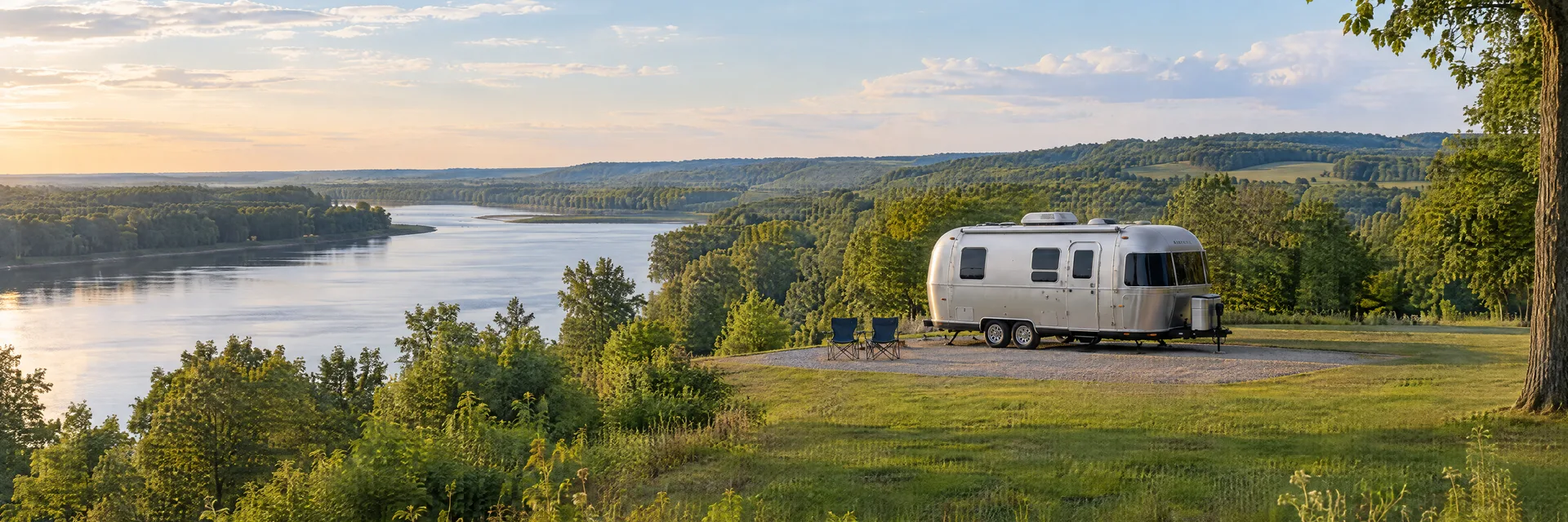 Illustration of a rounded silver travel trailer at a fictional camping setting inspired by Terre Haute, IN.