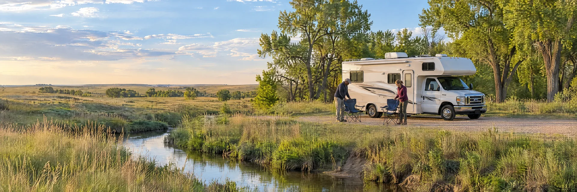 Illustration of campers enjoying setting up camp beside a Class C motorhome in a fictional camping setting inspired by Hutchinson, KS.