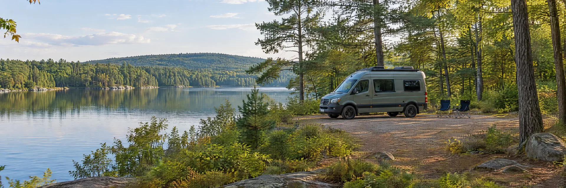 Illustration of a camper van at a fictional camping setting inspired by STURBRIDGE, MA.