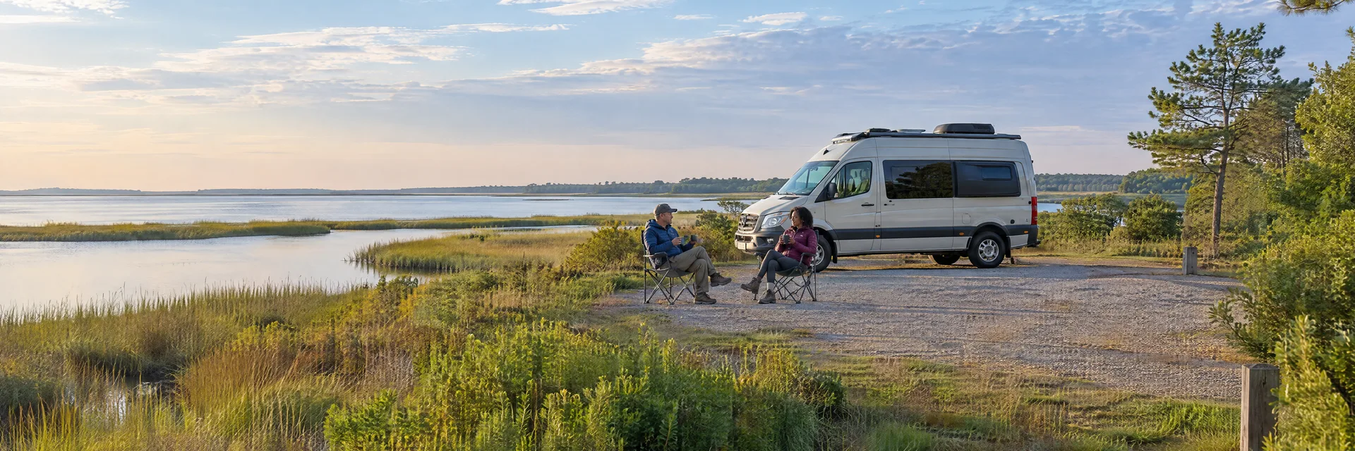 Illustration of campers enjoying morning coffee beside a camper van in a fictional camping setting inspired by Fishing Creek, MD.