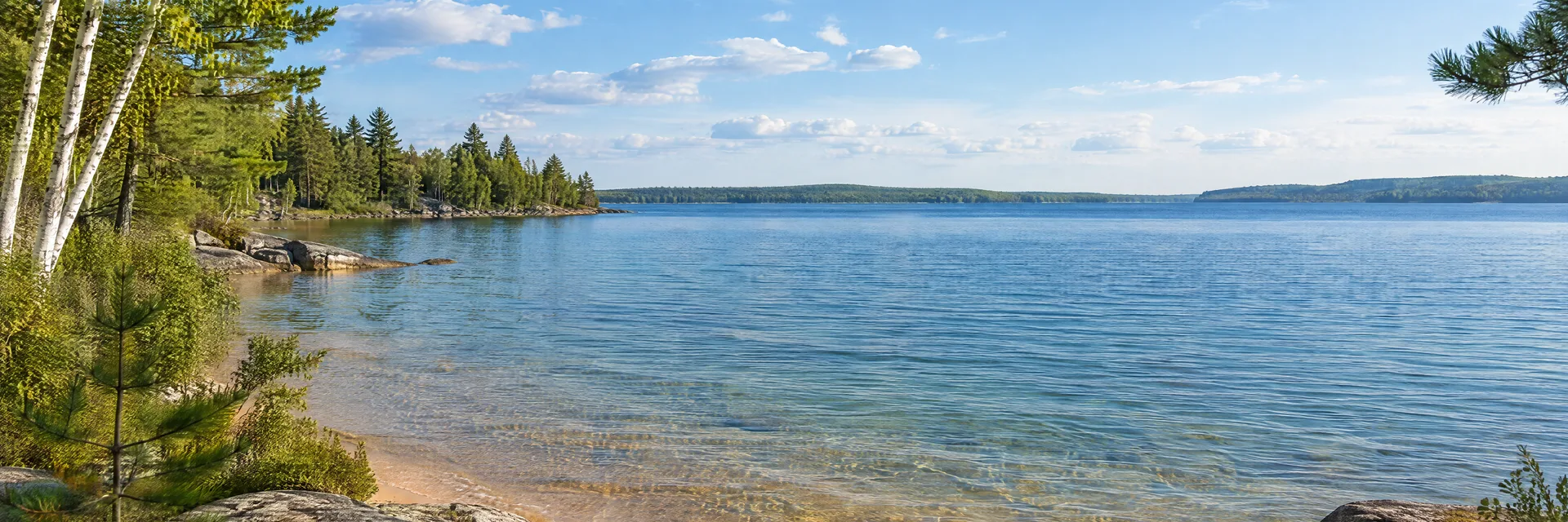 Illustration inspired by Indian River, MI: northern Michigan lake with sandy shallows and pine-birch shoreline.